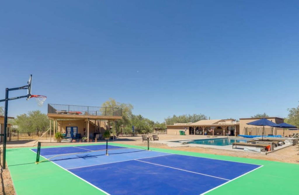 a tennis court with a basketball hoop on it at Oro Valley Guest House with Roof Top Views in Oro Valley