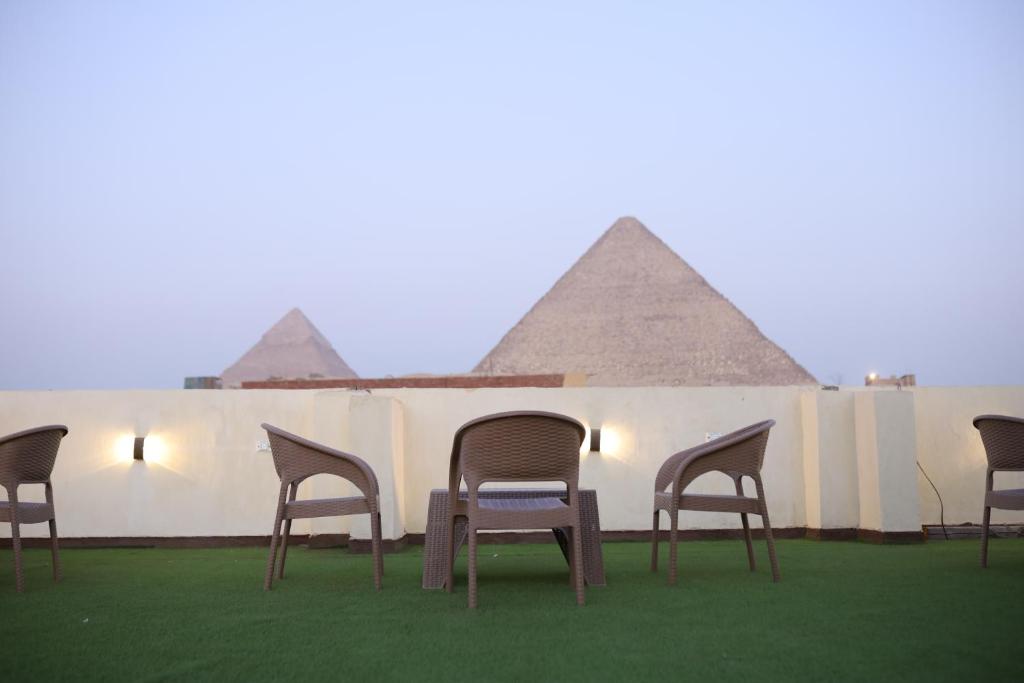 a group of chairs sitting in front of the pyramids at Retaj Pyramids View in Cairo