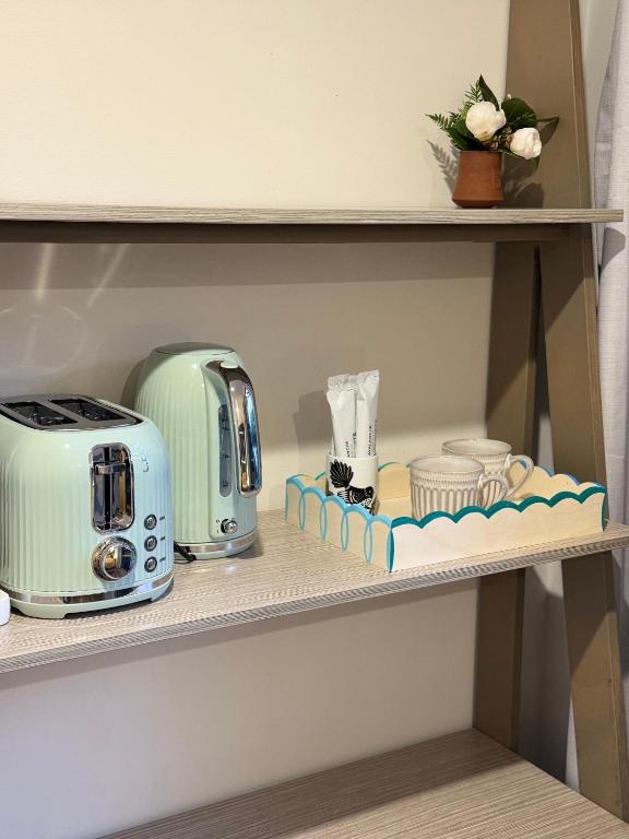 a shelf with a toaster and a toaster at The Kingfisher cabin in Tauranga