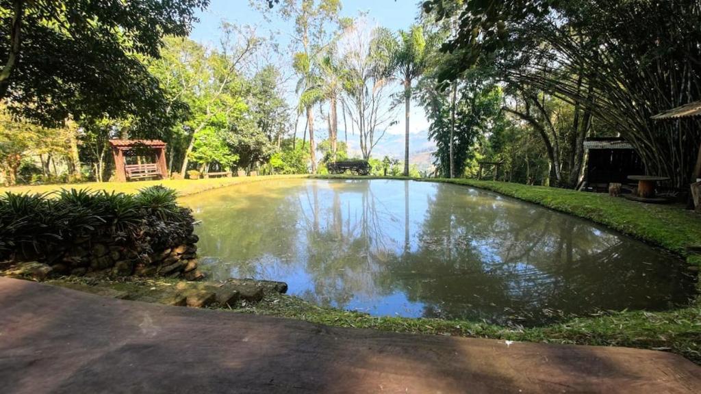 a pond in the middle of a park at Sítio Canto do Monte in Rolante