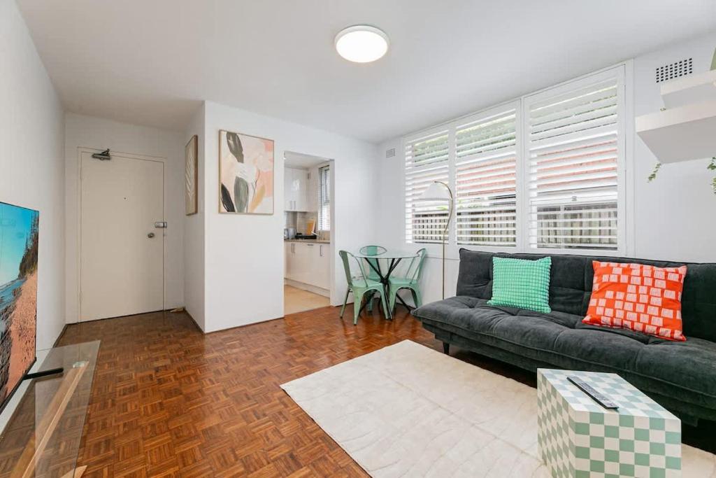 a living room with a couch and a table at Balmoral & Beyond Connected Comfort in Mosman in Sydney