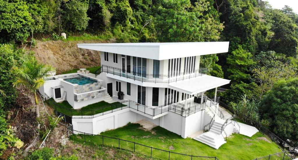 an overhead view of a white house on a hill at Luxury 4BR home with Infinity Pool, Jacuzzi & firepit in Playa Hermosa