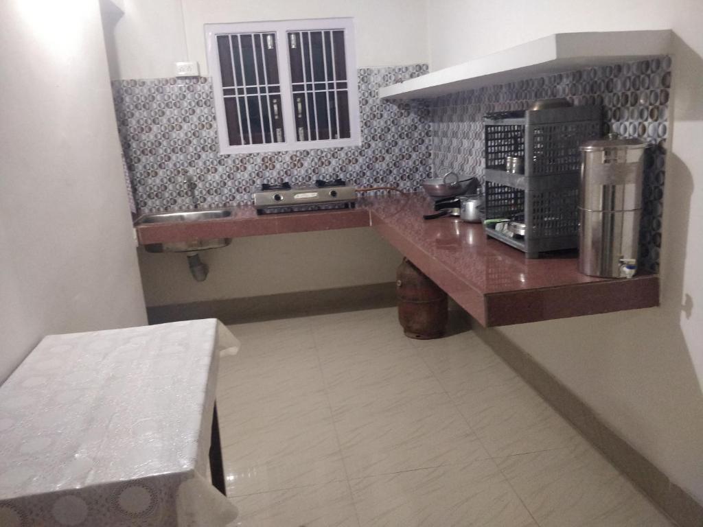 a kitchen with a counter with a coffee maker at Sanjukta Homestay in Nowgong