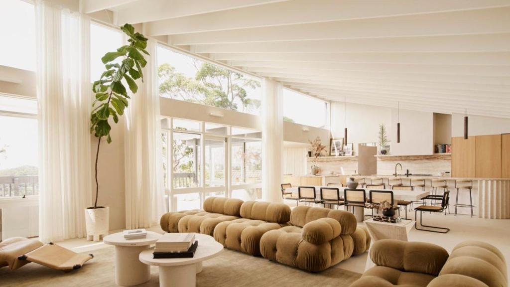 a living room with couches and a kitchen at Escape to Summer, Bilgola Plateau IH Luxe in Bilgola