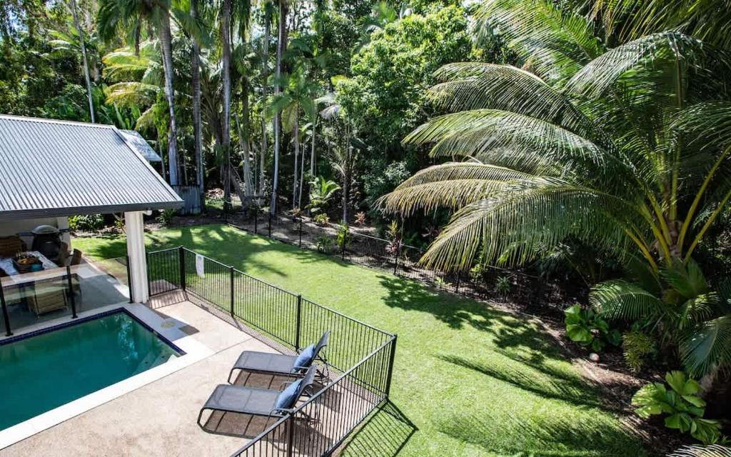 an aerial view of a backyard with a swimming pool at Cowrie Beach House Port Douglas in Port Douglas