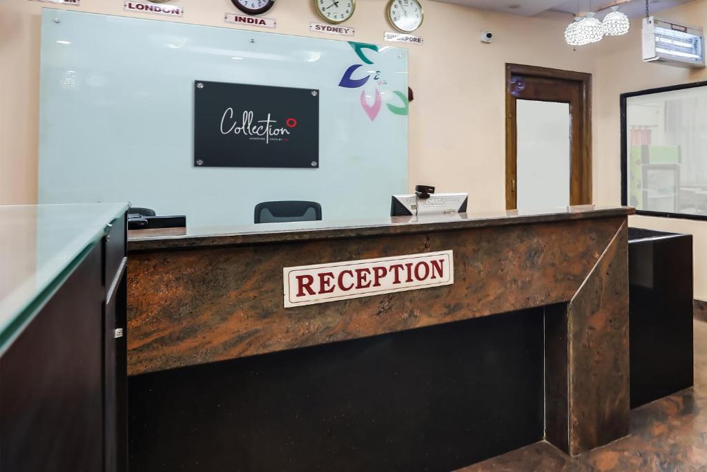 a reception desk with a sign that reads reception at Super Collection O Lotus Grand in Hyderabad