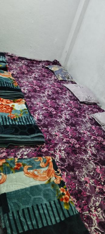 a room with a purple blanket on the floor at Shiv kripa guest house in Sehore