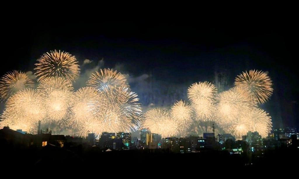 a fireworks display with a city in the background at 嘉翔の家 in Otsu