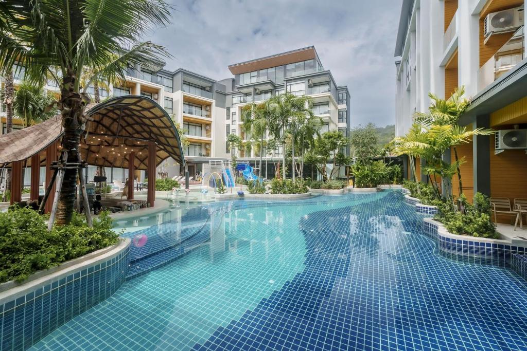 a large swimming pool in a building with a resort at Pool View Condo 2204 Wyndham Garden Resort in Nai Thon Beach