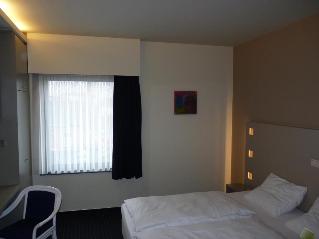 Postel nebo postele na pokoji v ubytování Hotel De Swaen