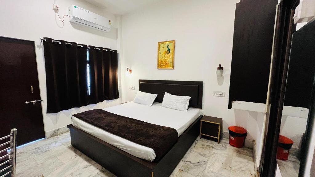 a bedroom with a bed in a room at Pushkar Stay in Varanasi