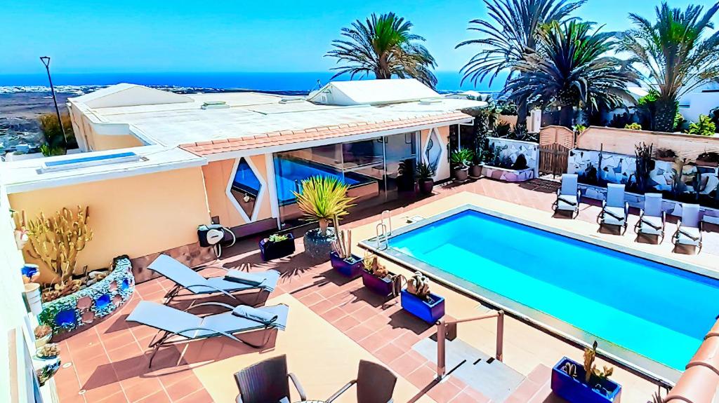 an aerial view of a house with a swimming pool at Villa MADORA - private pool, amazing garden, sea view, quiet location in Tías