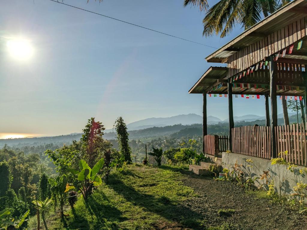 a house on a hill with a view at Haris Homestay & Cottages in Senaru