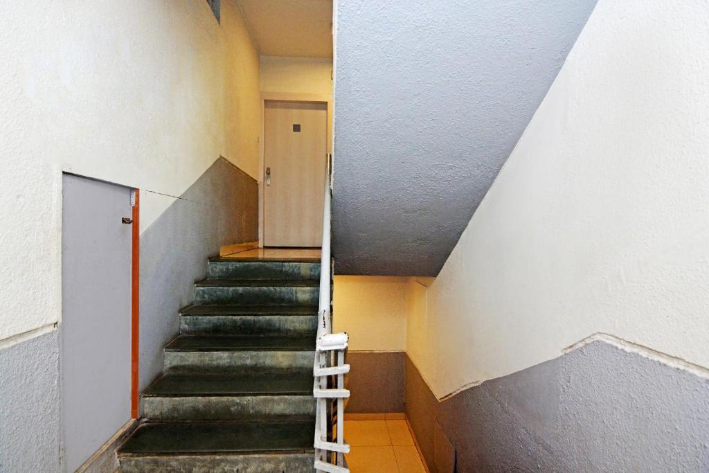 a staircase in a building with a stair case at Hotel O Ashwarya Service Apartment in Navi Mumbai