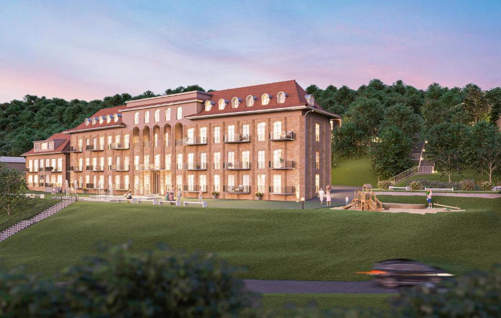 a large brick building with a park in front of it at Apartment Erfurt in Bad Frankenhausen