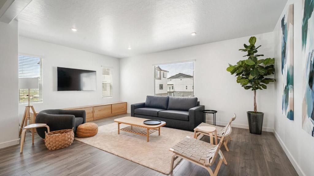 a living room with a couch and a table at Family-Friendly 3-Story Home Sleeps 8 in American Fork