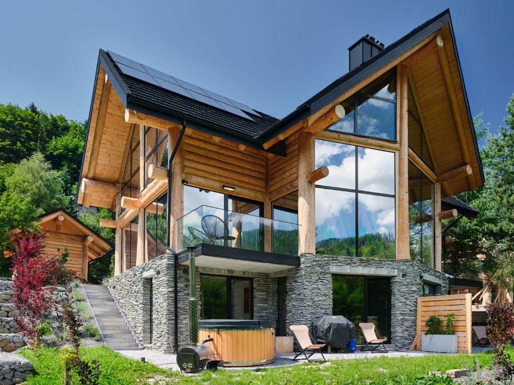 a large house with glass windows at Sęk w Ciszy - Free Sauna & Balia in Szczyrk
