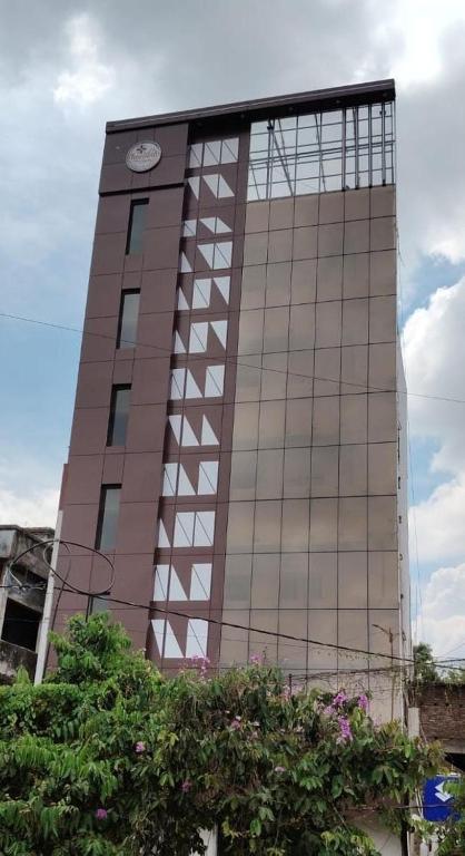 a tall building with a clock on it at Chocolate Inn, Patna in Patna