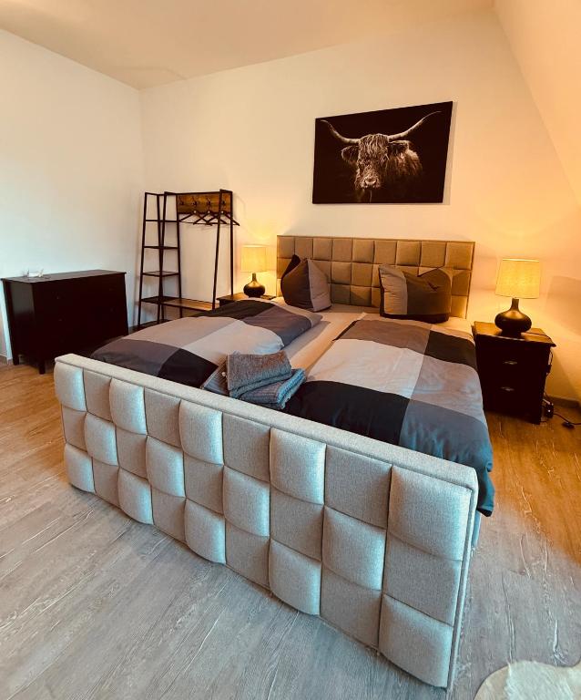 a large bed with a large tufted headboard in a bedroom at Talgarten Studio 6 in Erfurt