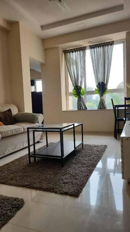 a living room with a coffee table and a couch at CASA HILLSIDE Dapoli 2BHK AC Apartment in Dapoli