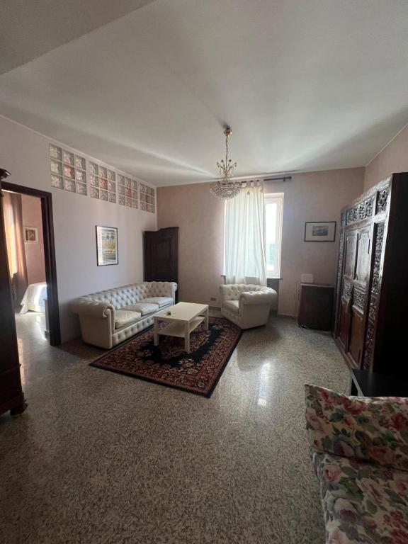a living room with a couch and a table at Appartamento Carlo Alberto in Bra