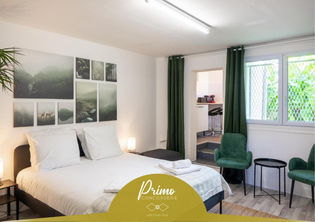 a bedroom with a bed and two green chairs at Orléans - Le Green Mood in Orléans