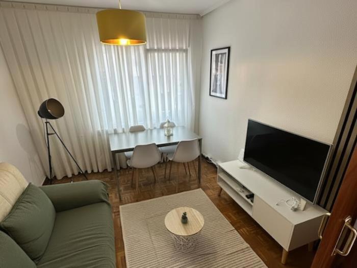 a living room with a couch and a tv and a table at Living Haro by Clabao in Haro