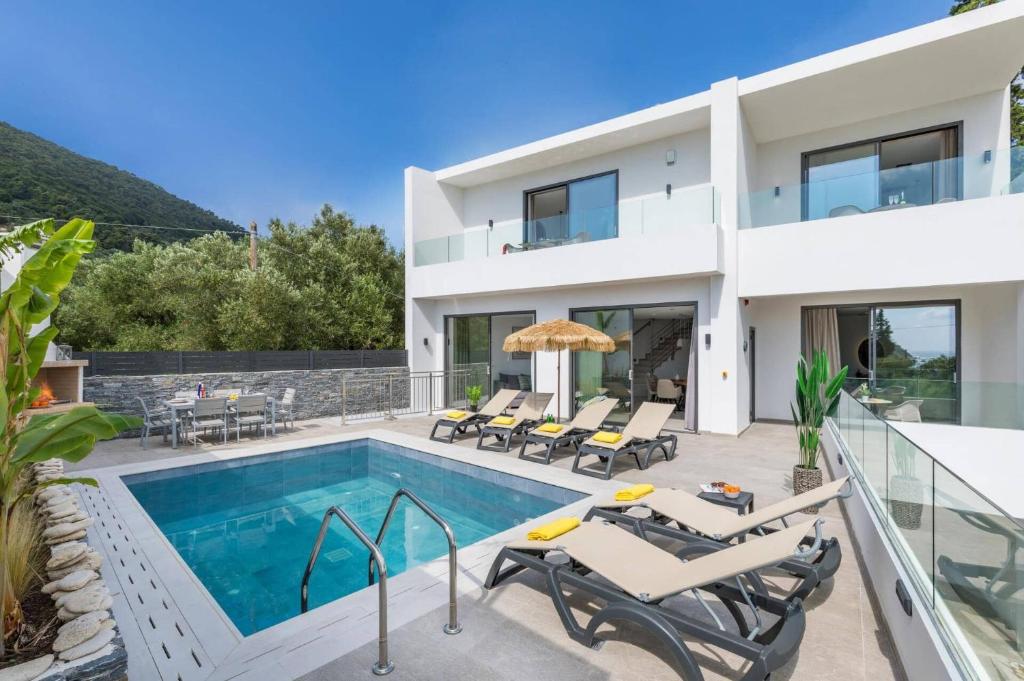 a villa with a swimming pool and patio furniture at Villa Bougainvillea Boutique 3 by Villa Plus in Marathias