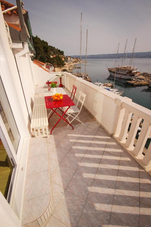 a patio with a table and chairs on a balcony at Apartmani Kristijan in Jesenice
