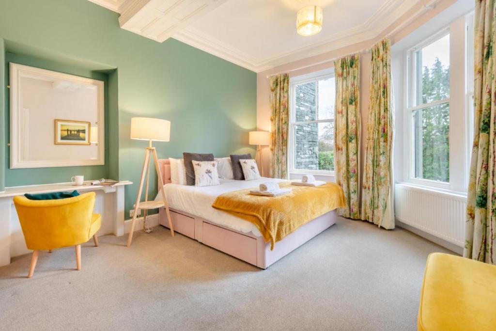 a bedroom with green walls and a bed and a window at Redwood Rise Apartment Keswick at The Lairbeck in Keswick