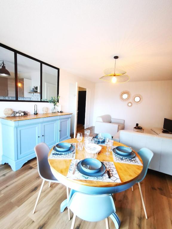 a dining room with a table and a couch at Chez Manue et Ludo centre ville in Thonon-les-Bains