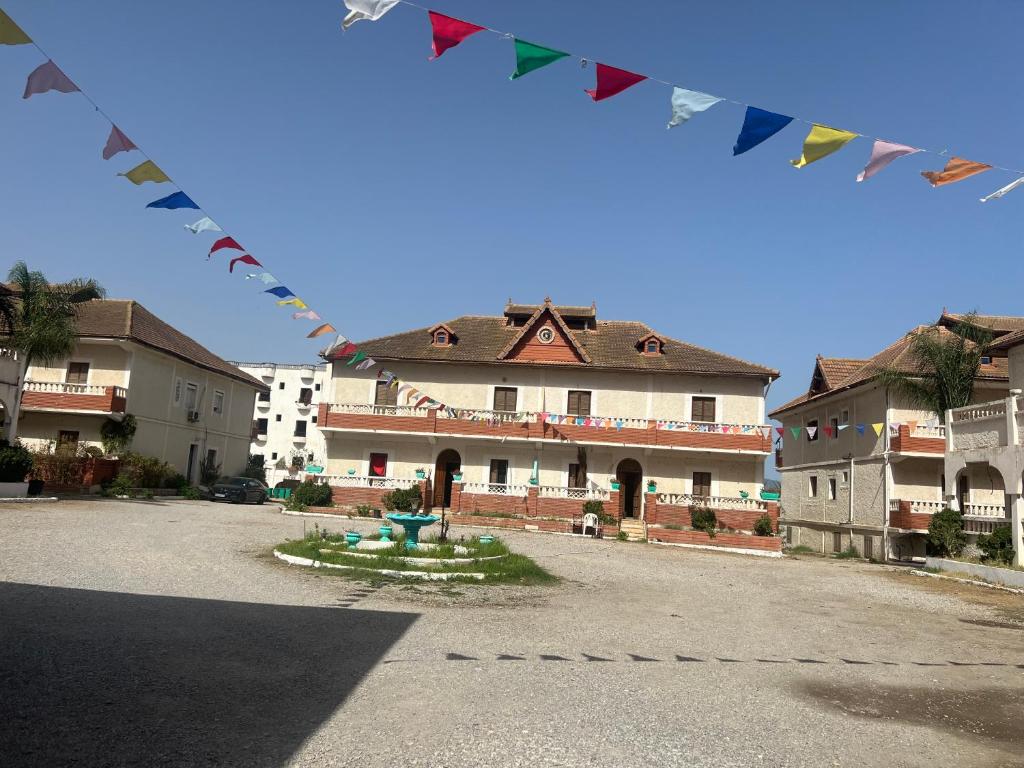 a building with flags in front of a courtyard at Diafet chatt 