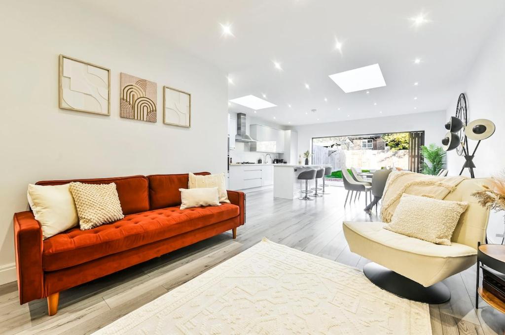 a living room with a brown couch and a table at Stylish House Near Wembley Stadium in London