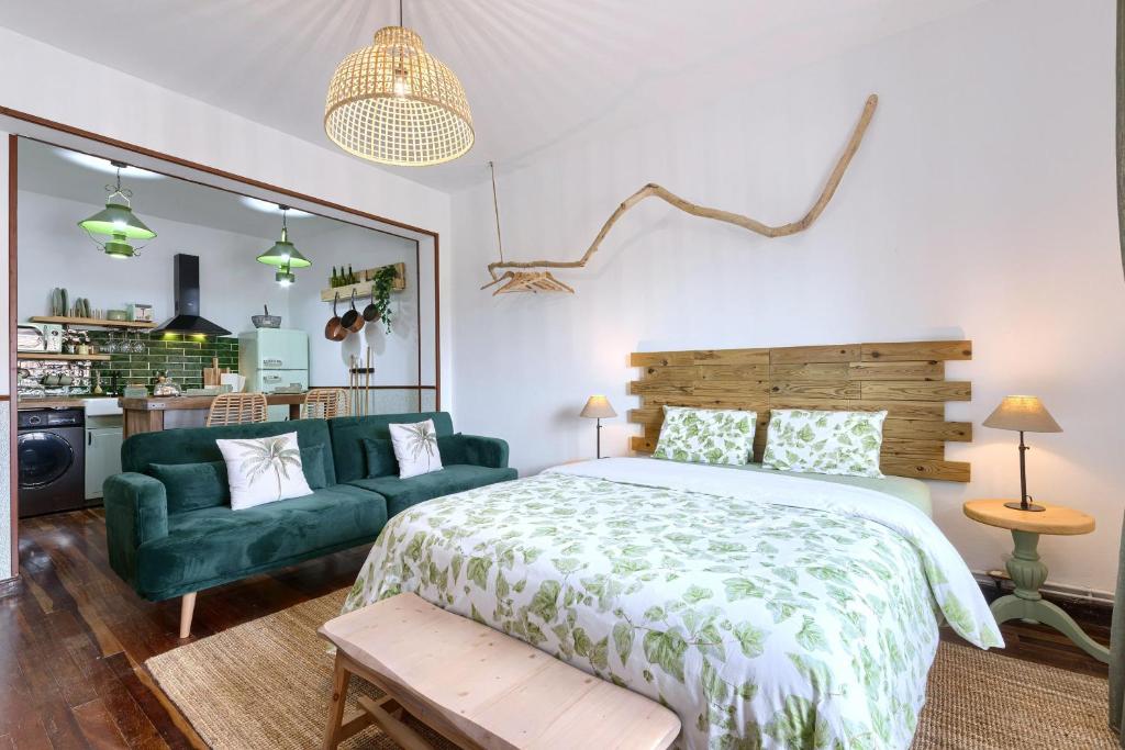 a bedroom with a green bed and a green couch at Zamudio Cozy Room By Next Stop Bilbao in Zamudio