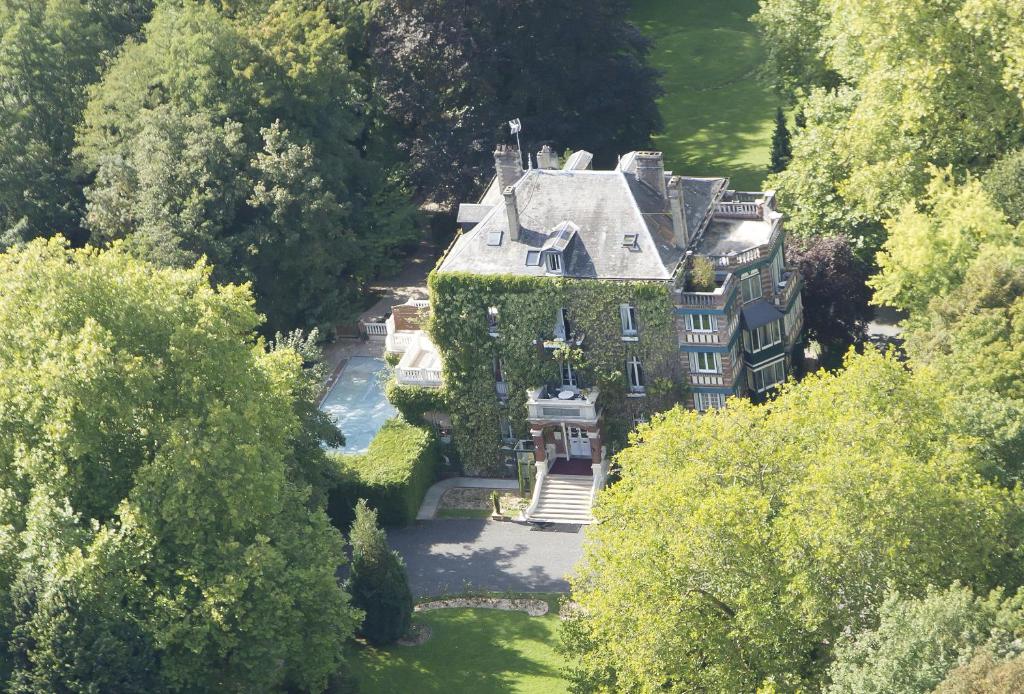 an aerial view of a large house with ivy at Hotel Belle Isle Sur Risle in Pont-Audemer