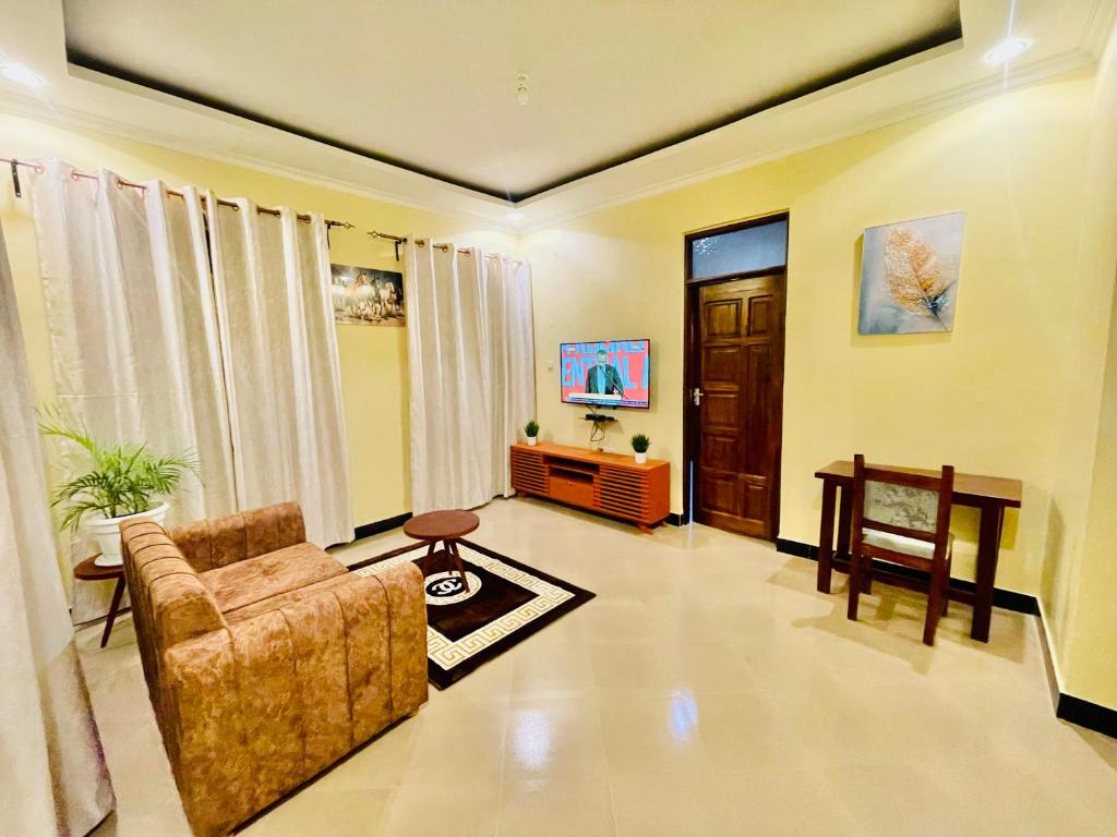 a living room with a couch and a table at Sk homes Dodoma in Dodoma