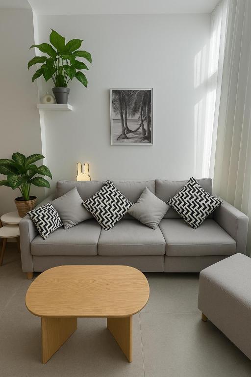 a living room with a couch and a coffee table at Sunny Escape 1BR with Pool Access in Hurghada