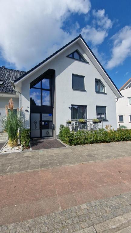 a white house with a large glass door at The Ferienwohnung in Bremen
