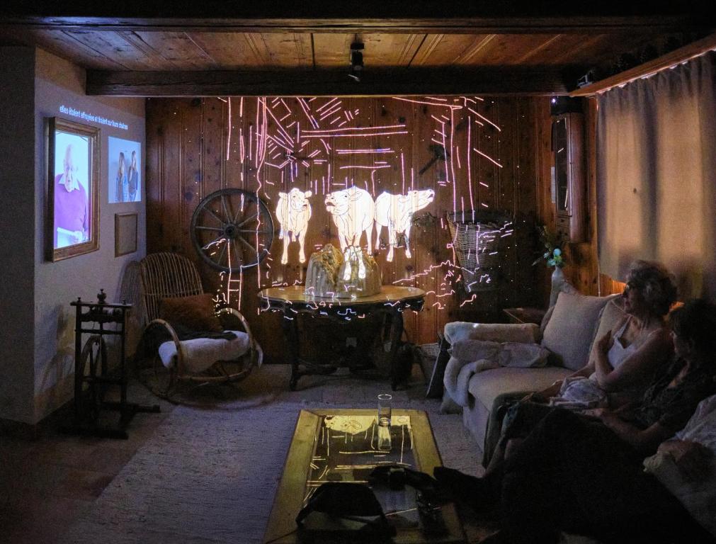 a group of people sitting in a living room at Bed&Museum Alpine Nomads in Chalais