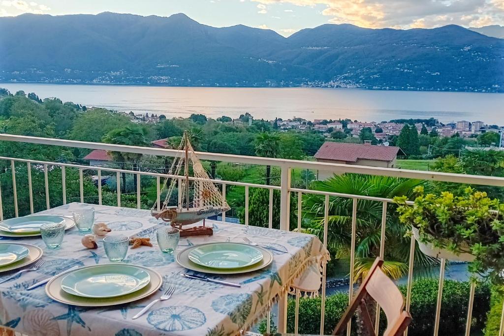 a table on a balcony with a view of a lake at Panorama e Relax in Germignaga