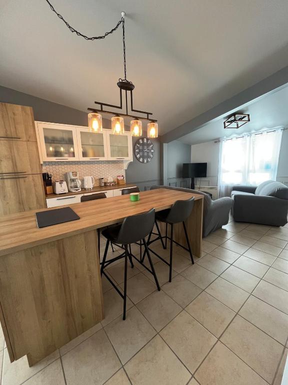 a kitchen with a large wooden table and chairs at Le Numéro 1 in Val-Brillant