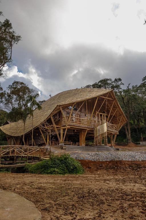 a large wooden building with a gambrel roof at KaatiKaadu in Sakleshpur