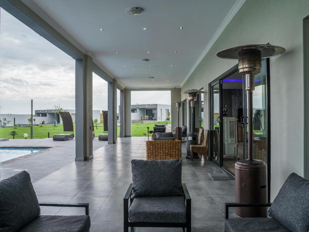 a living room with chairs and a view of the ocean at Humdani Safaris Free State in Virginia