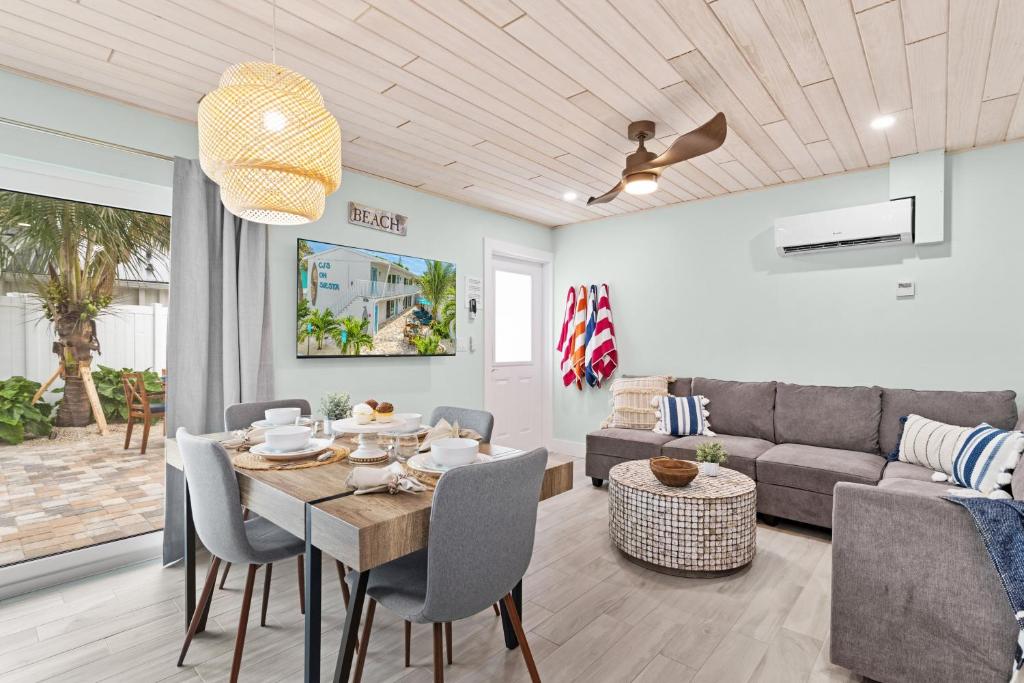 a living room with a table and a couch at Sea Dream - Pet Friendly, Located in Siesta Key Village, Steps to Siesta Key Beach! in Bailey Hall