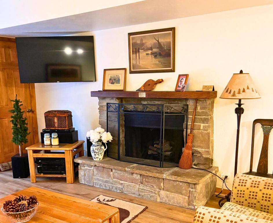 a living room with a fireplace with a tv at Park Station 3 min walk to Town Lift and Main St in Park City