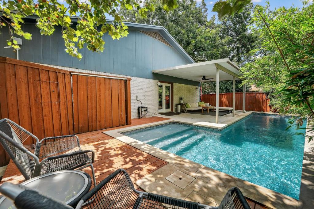 a swimming pool in the backyard of a house at Stylish 3BR Home + Private Pool in Austin