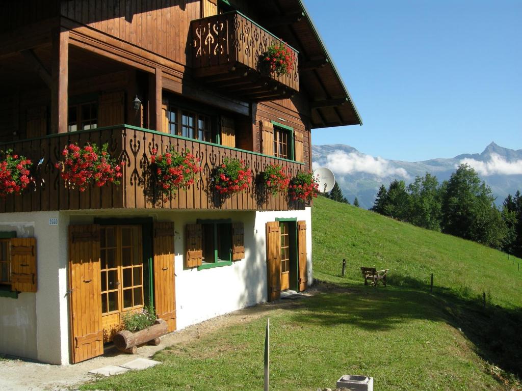 a building with a balcony and flowers on it at Chalet Marie Paradis in Saint-Gervais-les-Bains