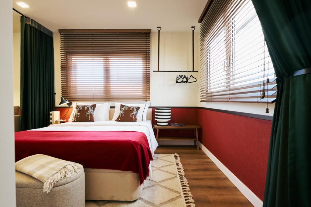 a bedroom with a large bed and a red wall at Espaço Quattro Apartamentos in Fátima