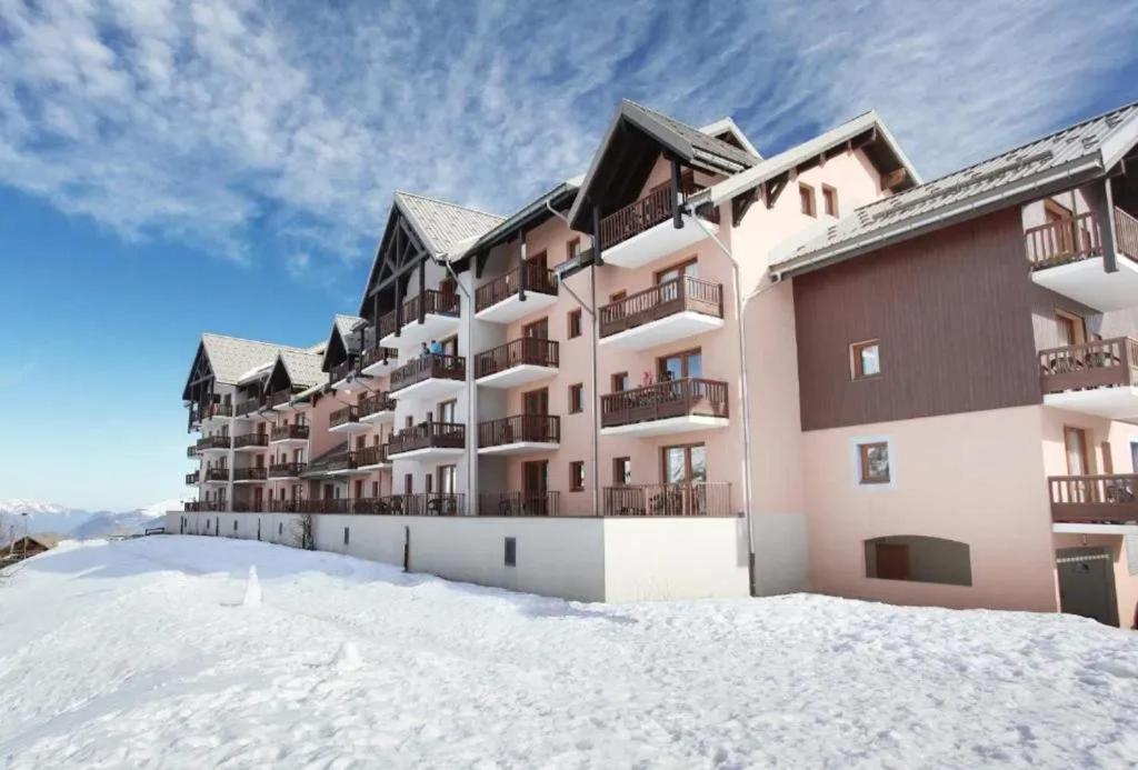 ヴァルマニエにあるAppartement cosy à Valmeinier avec vue montagne et piscineの雪の中の大きなアパートメントビル