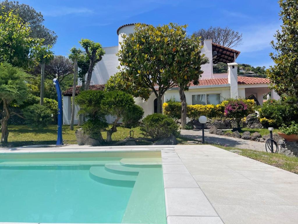 a house with a swimming pool in front of it at Villa Valè con piscina in Ischia